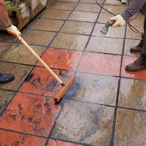 Brush in patio grout being applied to paving joints